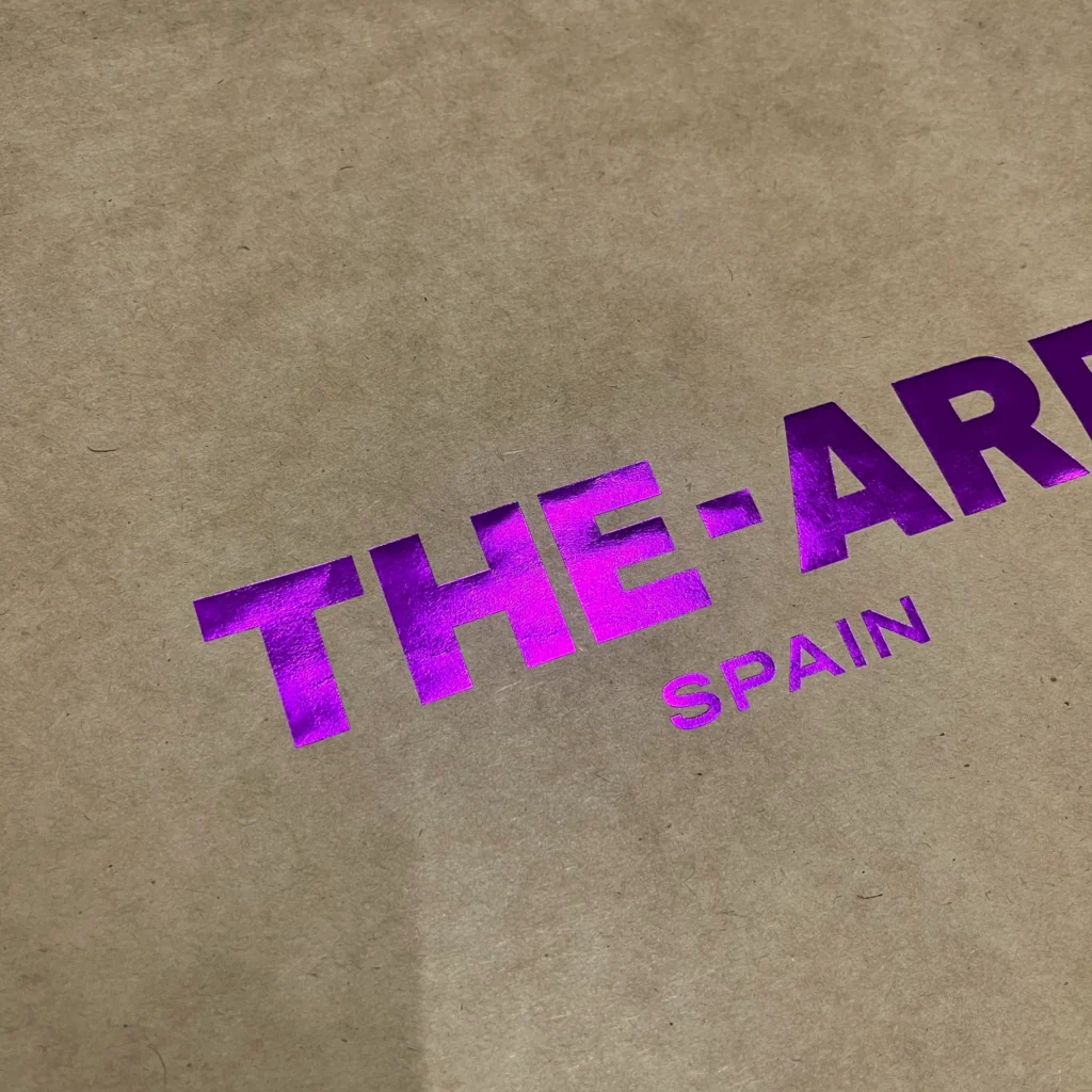 Premium purple hot stamping foil logo on eco-friendly brown kraft paper box by ZY Pack, showcasing vibrant metallic texture and sustainable luxury packaging design