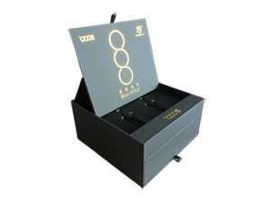 A premium matte black rigid gift box for men featuring a flip-top lid and a bottom sliding drawer with ribbon pull. Expertly crafted by ZY Pack with gold foil stamping and custom internal inserts, showcasing 15 years of luxury packaging expertise for global retail brands
