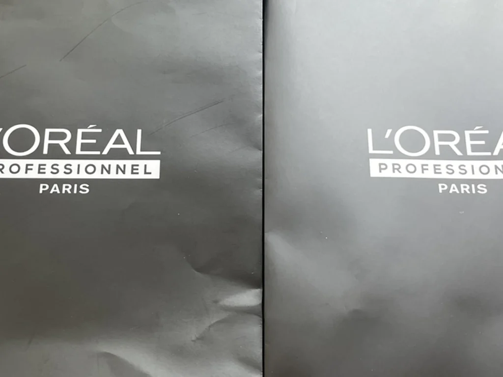 Macro comparison of ZY Pack anti-scratch matte lamination vs. standard matte lamination on a black printed paper packaging, showcasing superior scratch resistance for luxury packaging.