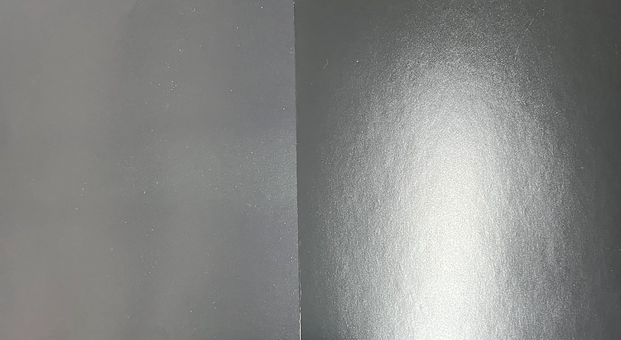 Micro-lens comparison of 100% black ink: UV printing (no spray powder, pure black) vs offset printing (white powder dots, muted black) by ZY Pack.
