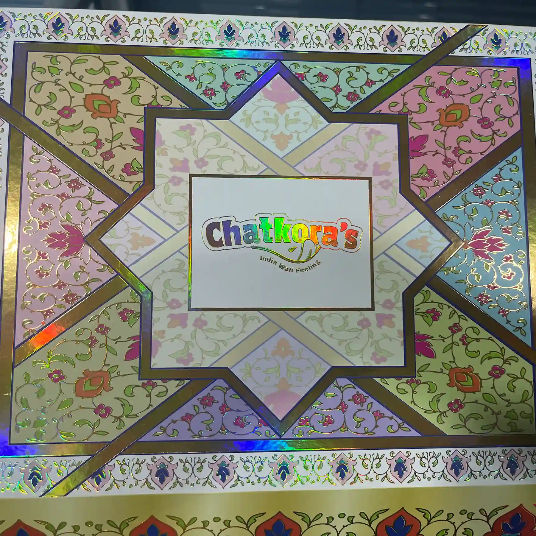Intricate holographic laser foil stamping and precision gold hot foil on a luxury rigid box by ZY Pack