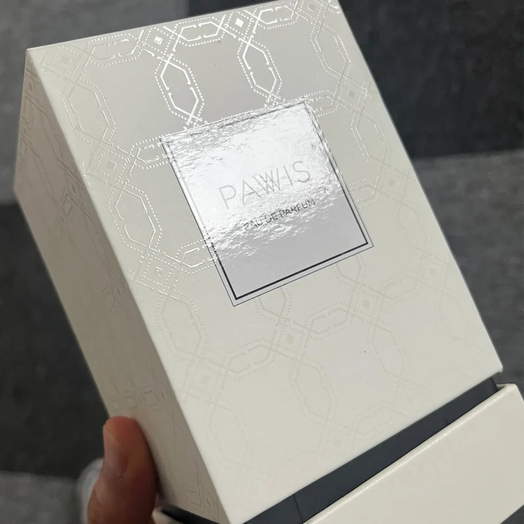 Premium perfume box for PAWIS featuring intricate blind spot UV geometric patterns on white specialty paper, demonstrating high-end tactile finish by ZY Pack