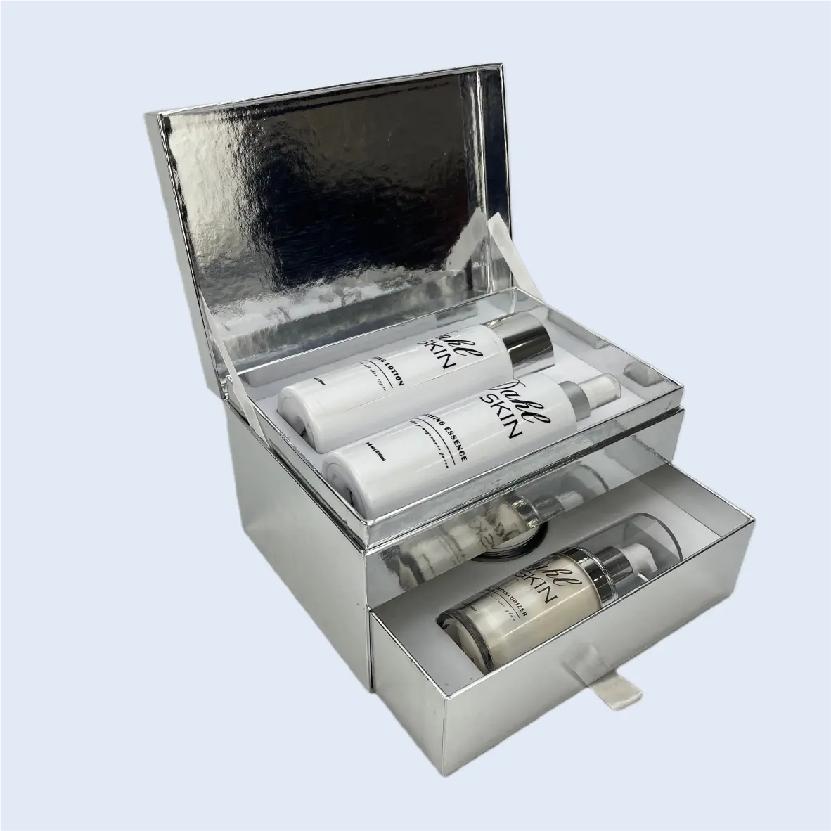 Beauty & Skincare Packaging Luxury silver cardstock cosmetic set packaging by ZY Pack, featuring a unique hybrid design with a magnetic flip-top upper compartment and a sliding drawer base for premium skincare kits.
