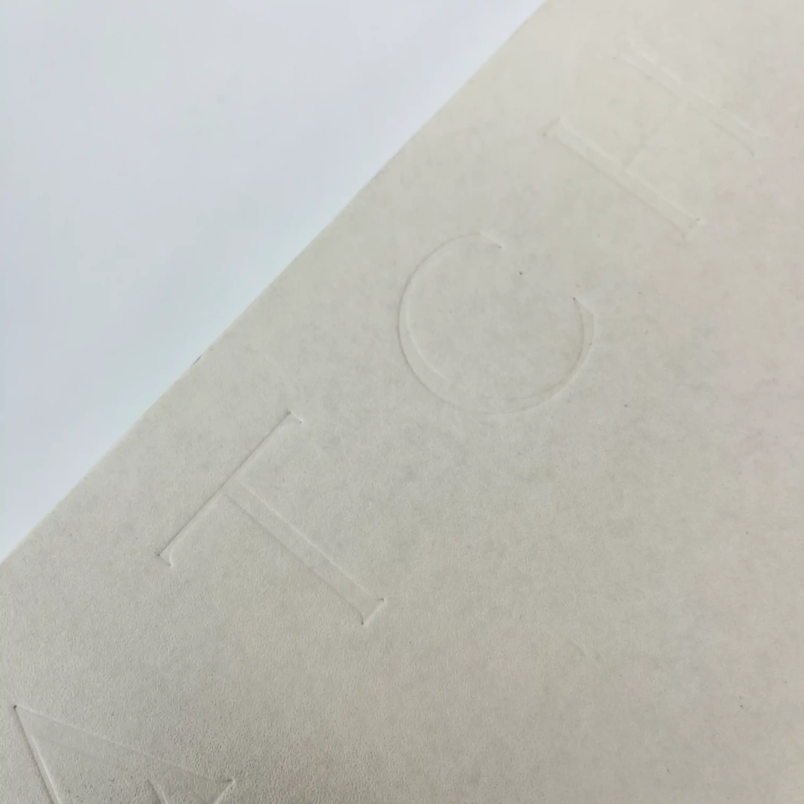 Minimalist blind debossing on luxury paper by ZY Pack, highlighting recessed texture

