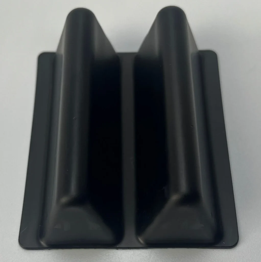 Black injection-molded plastic tray stand featuring thick walls, smooth solid finish, and high precision. Designed for heavy-duty use and mass production.