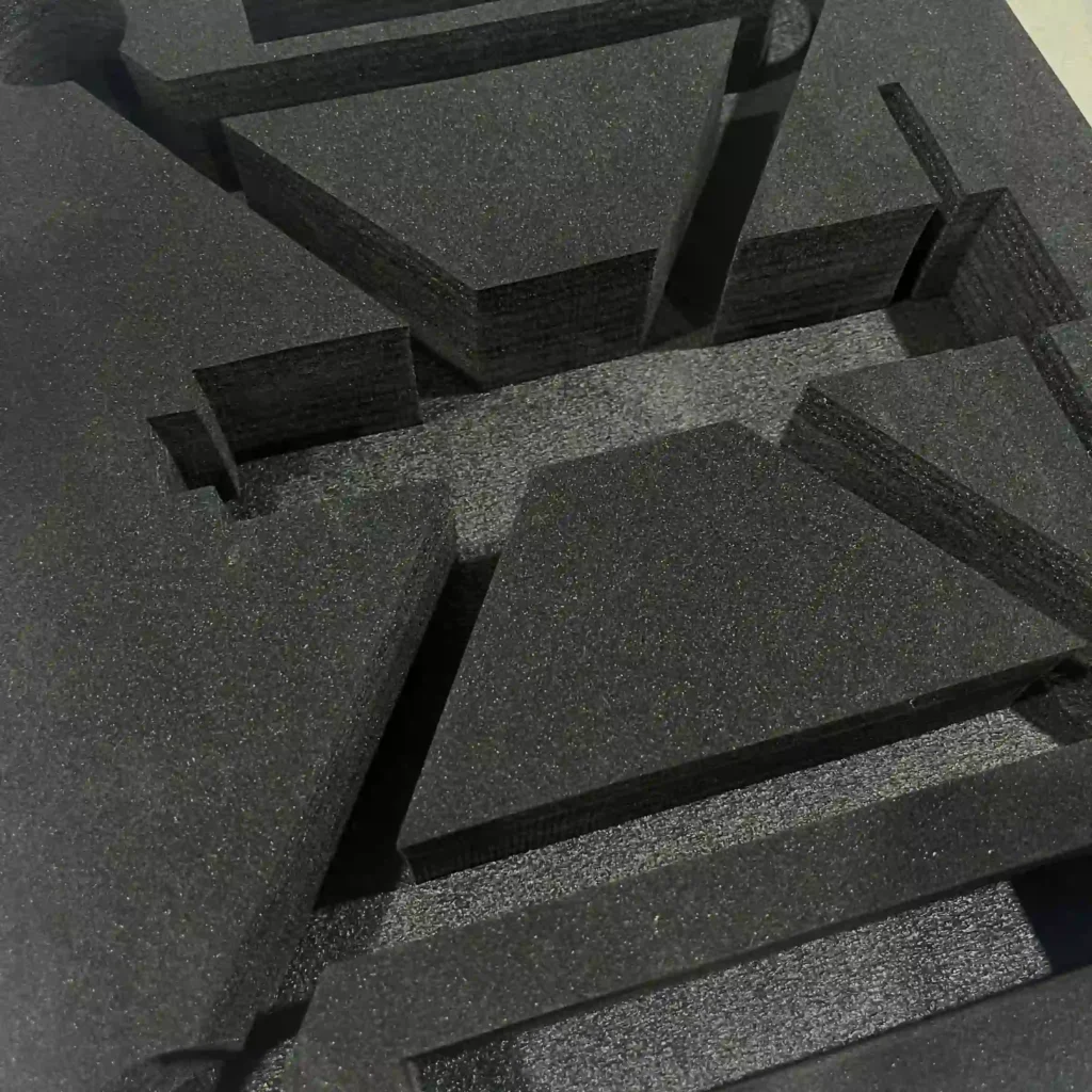 Black EVA-laminated insert with high-density EPE foam core. Features a semi-fine cell structure that is smoother than low-density EPE, offering a cost-effective alternative to solid EVA for large volume items.