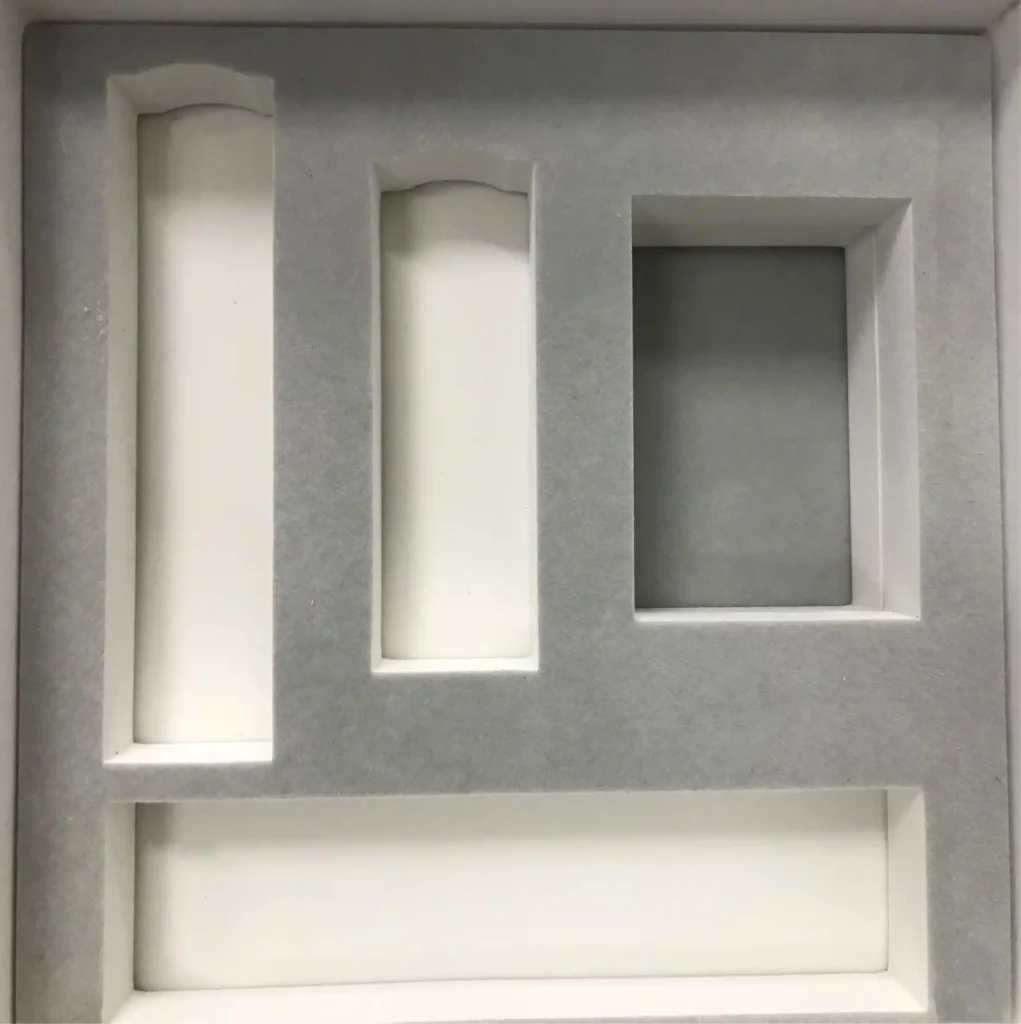 Close-up of a black high-density EVA foam insert holding a ceramic mug. Shows the rigid structure, matte texture, and ultra-sharp die-cut edges characteristic of premium Grade A EVA foam.