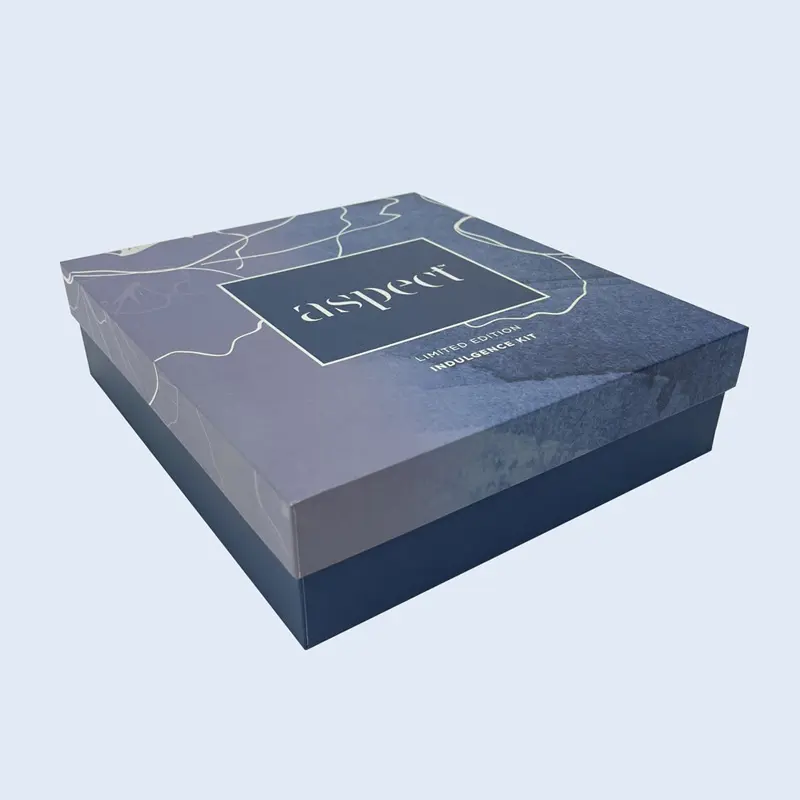 A premium 2-piece rigid gift box (lid and base) with a deep blue artistic textured lid and solid base for Aspect Skincare's Indulgence Kit. Custom manufactured by ZY Pack in Wenzhou, China.