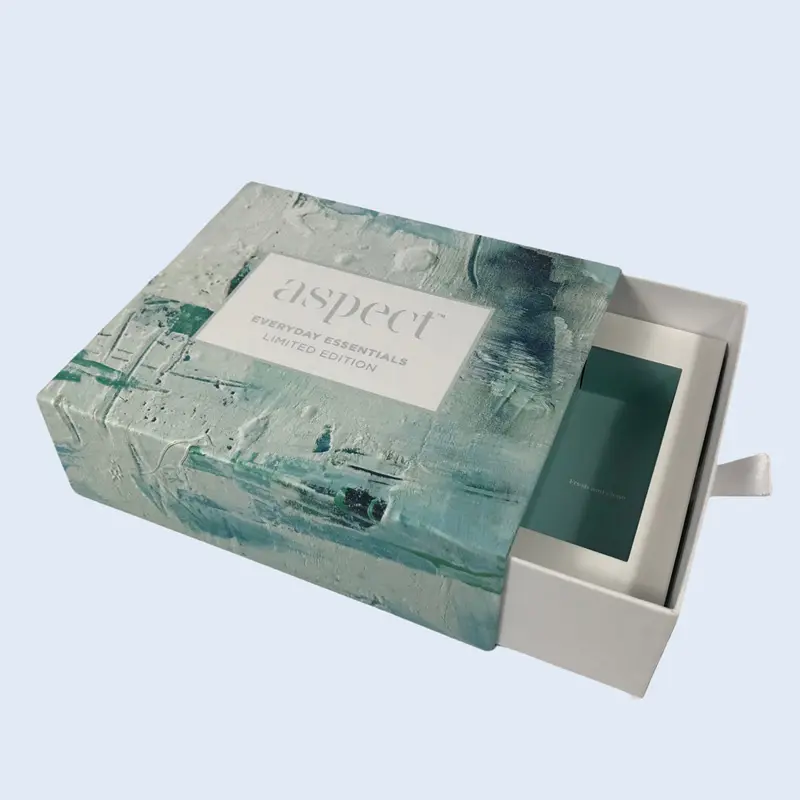 A luxury sliding gift box (drawer box) with a teal artistic textured finish and ribbon pull-out, custom-made for Aspect Skincare. Manufactured by ZY Pack, an FSC-certified factory in Longgang, Wenzhou.