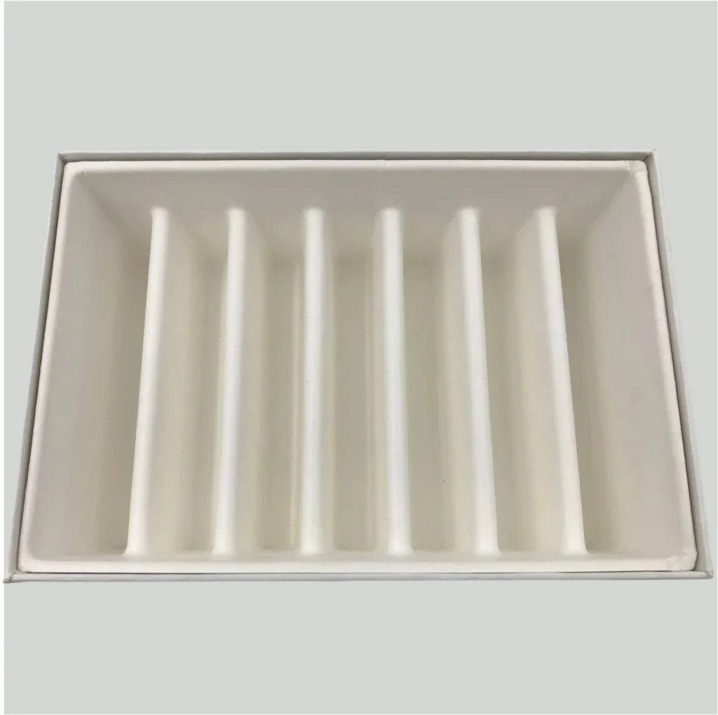 Top view of a white biodegradable molded pulp tray with 7 compartments. Features sharp edges and a smooth surface finish characteristic of wet-press technology.