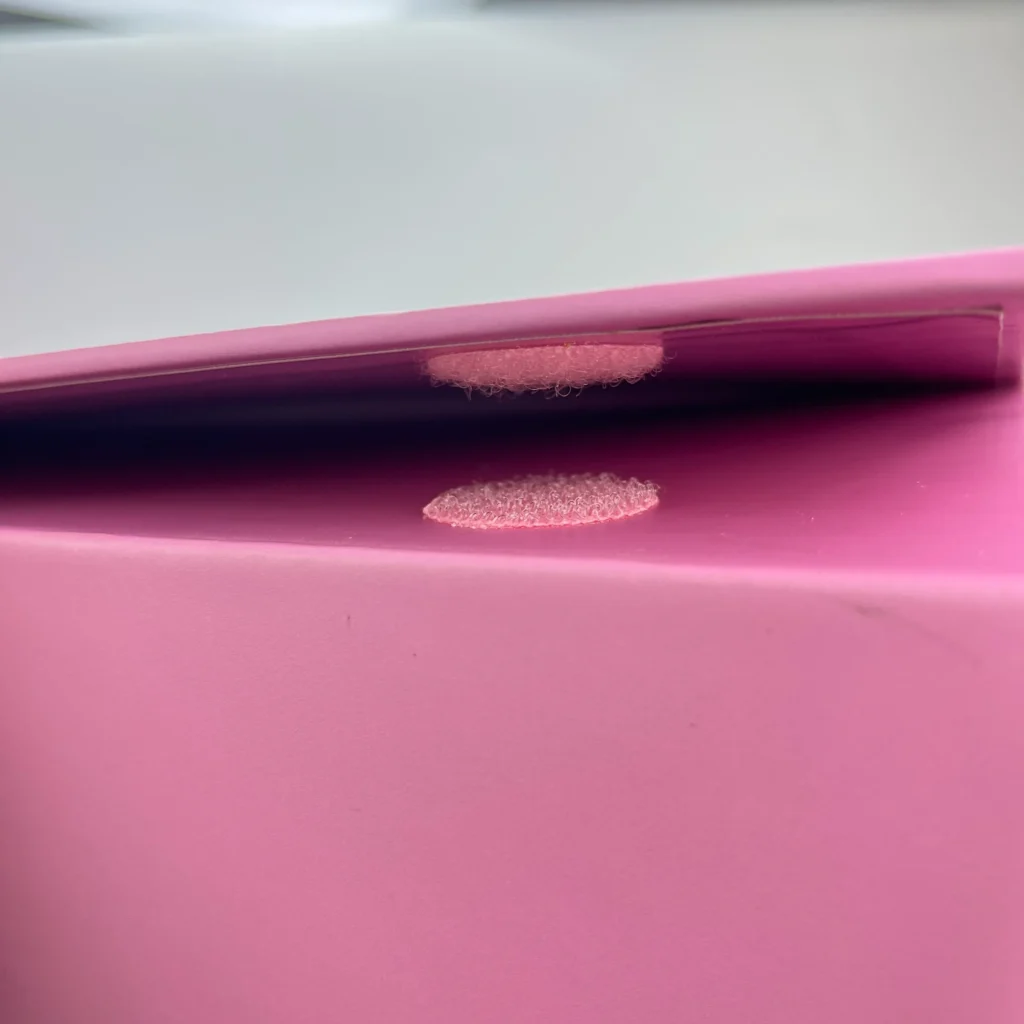 Close-up view of the Velcro closure sealing on an oversized collapsible rigid box, demonstrating perfect flush alignment and a sleek profile.