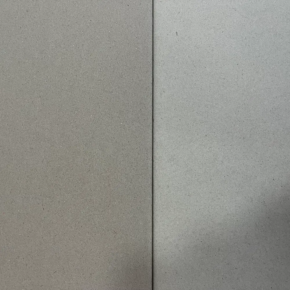 Comparison showing the superior surface smoothness of ZY Pack high-density glossy paperboard versus standard porous greyboard for luxury packaging.