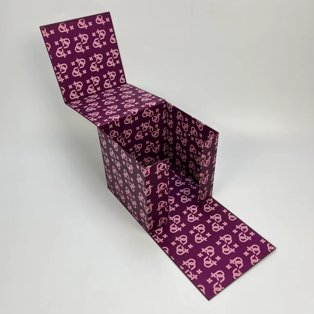 Multi-magnet cube folding rigid box open lid angled view showing full custom monogram print covering interior lid walls and base for premium luxury gift packaging