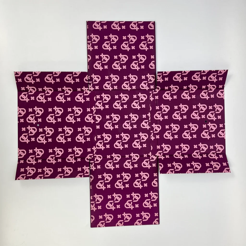 Multi-magnet cube folding rigid box unfolded flat in cross panel layout showing full surface custom monogram print pattern for luxury gift packaging