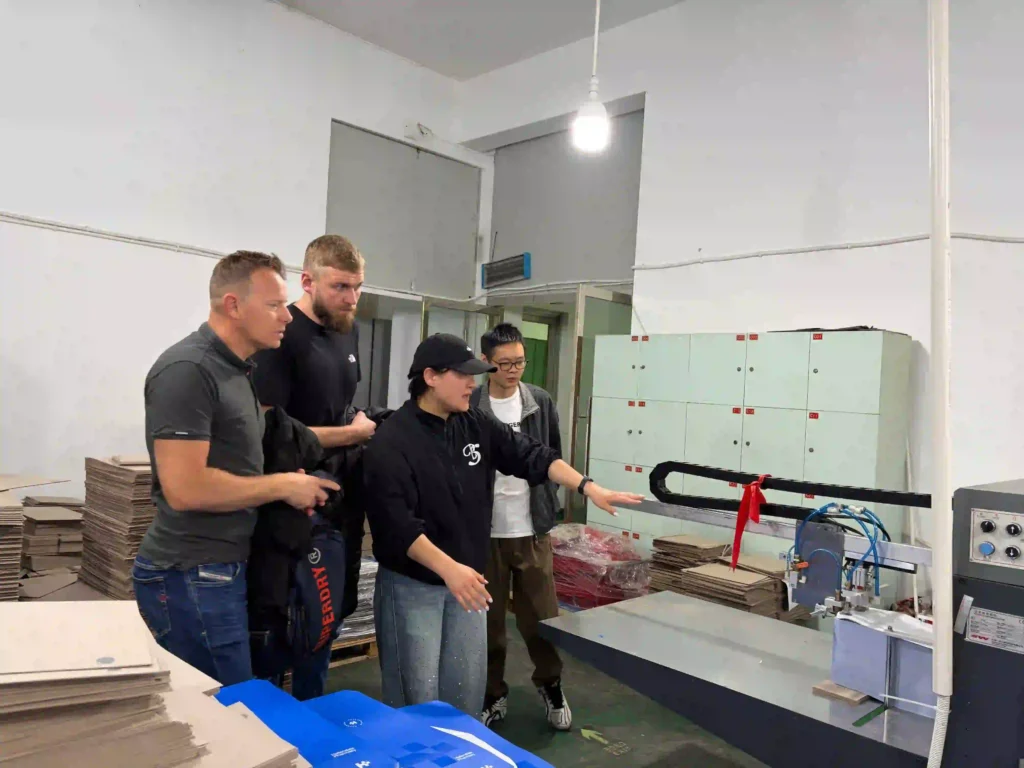 Automated packaging assembly line demonstration at ZY Pack facility ZY Pack team explaining automated feeding system to TDI Tuning UK client
