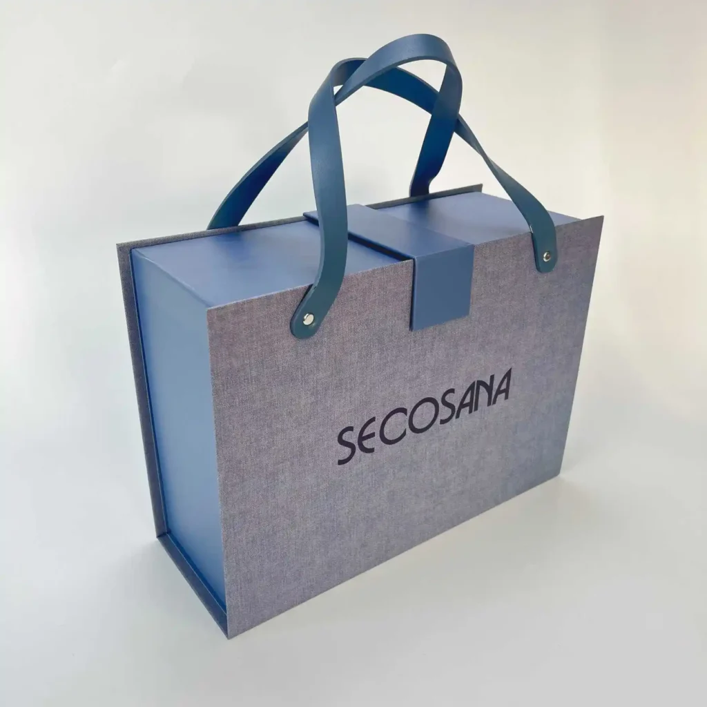Grey linen texture magnetic foldable rigid box with blue PU leather handle and paper tab closure for upscale retail gift packaging