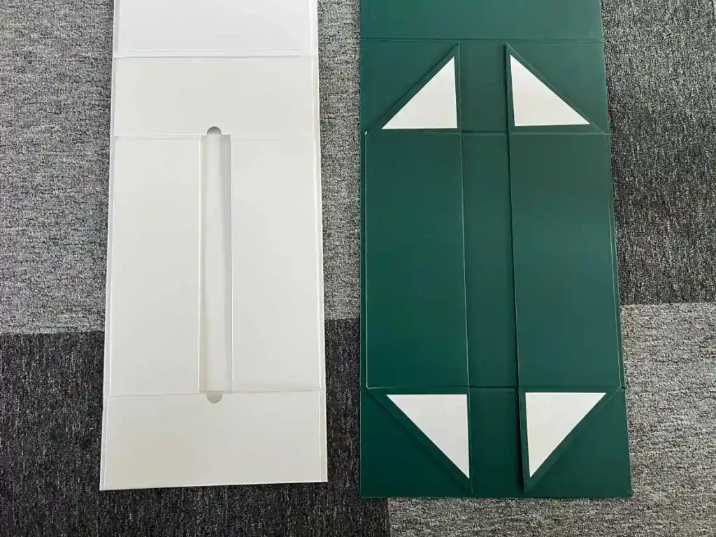 Flat pack comparison of white snap-lock collapsible box and green adhesive tape magnetic folding box showing folding panel structure